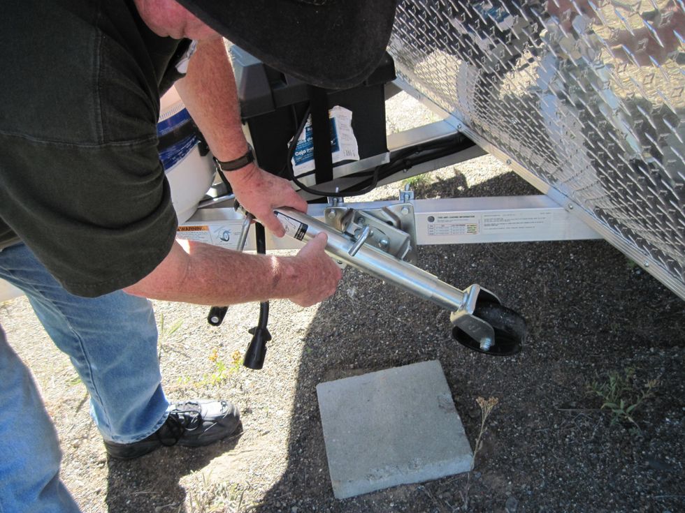 Pull the pin lock out to free the wheel and spin the stem up so the wheel is stowed level and out of the way. It will clunk when in the right position.