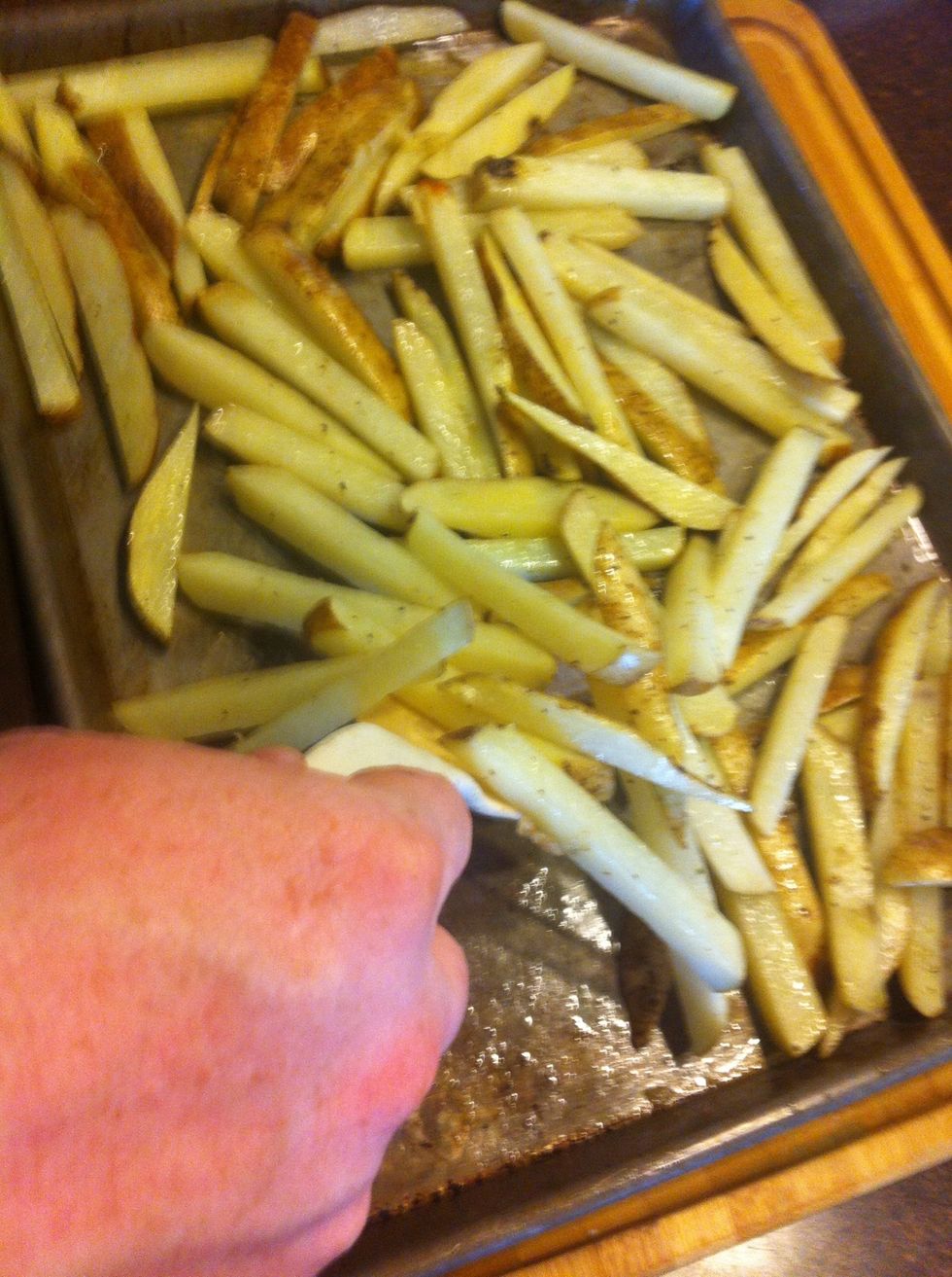 Pull the potatoes out, gently scrape the fries off the bottom of the sheet, rotate them, and place back in the oven for another 10 minutes