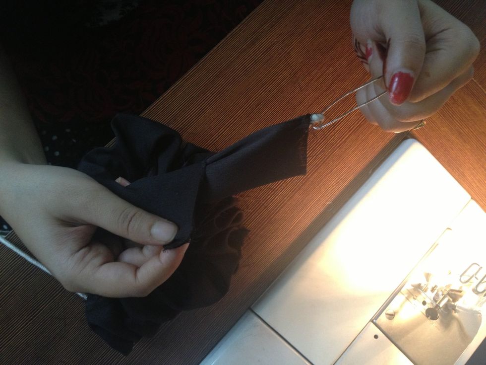 Pull the safety pin from the other side of the tube. So the stitched part will get inside & the satin shiny part will come out resulting in a shiny satin tube where you wont see the stitches anymore.