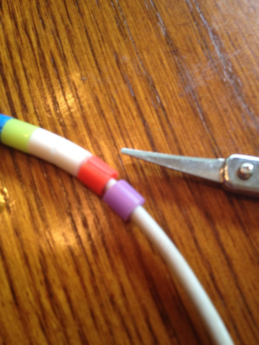 Pull the scissors out and the bead will stay on the cord