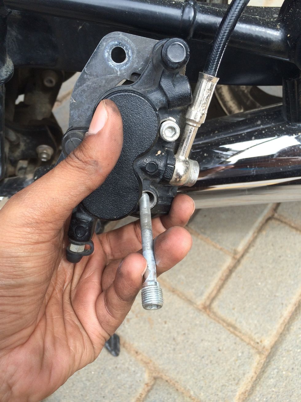 Pull the second retaining pin out, you may have to push the pads inward of the caliper to get the pins out