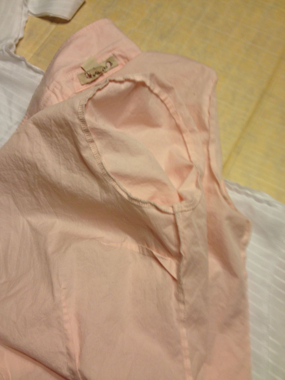 Pull the sleeves inward to expose the armholes.