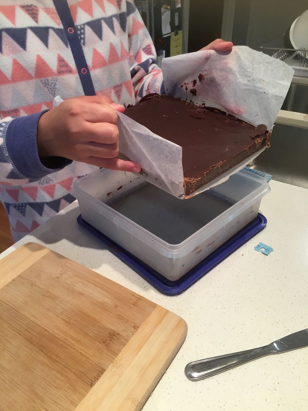 Pull the slice out of the container, if it doesn't come out easily go around with the knife again.