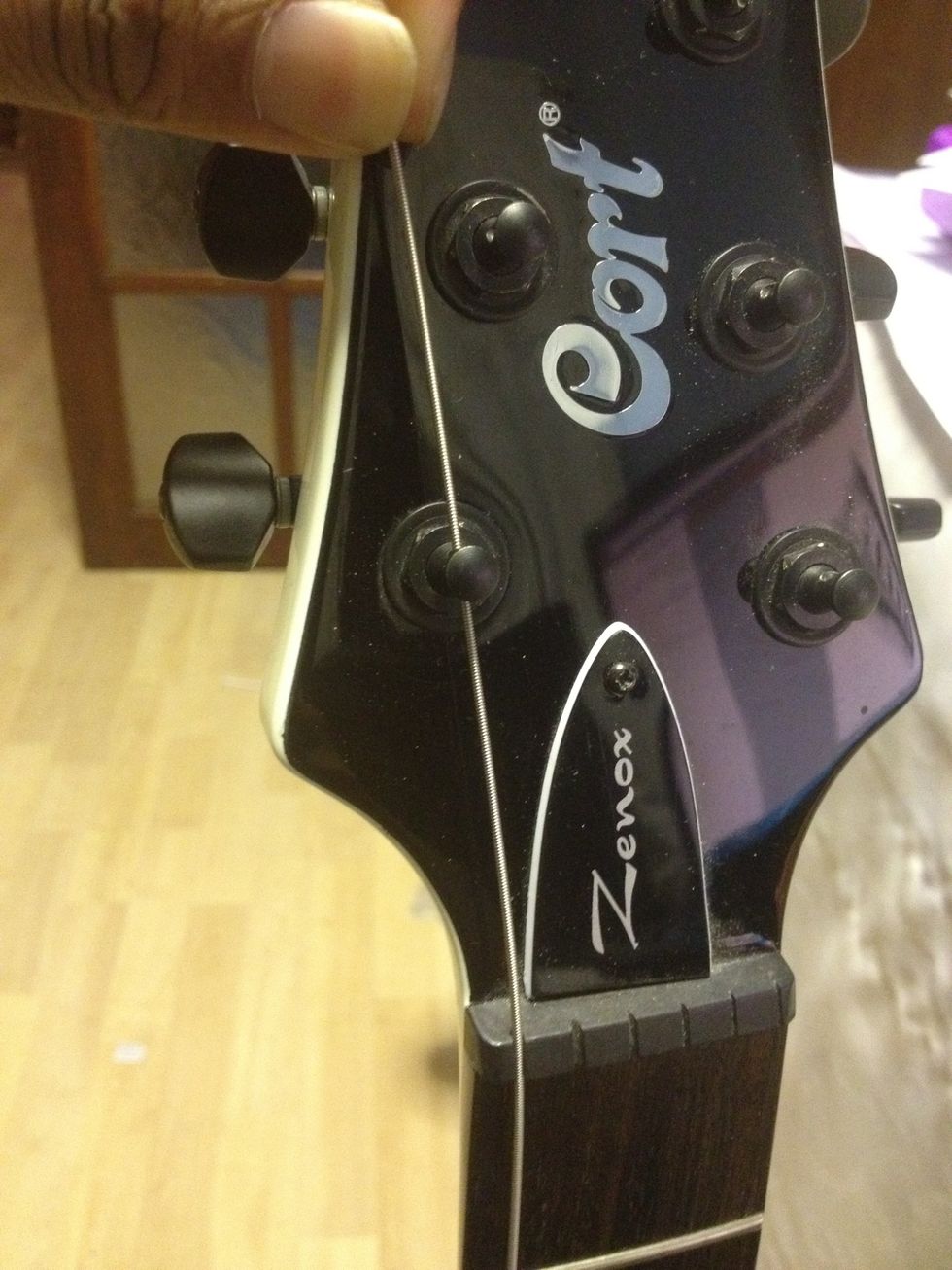 Pull the string through the guitar nut hole