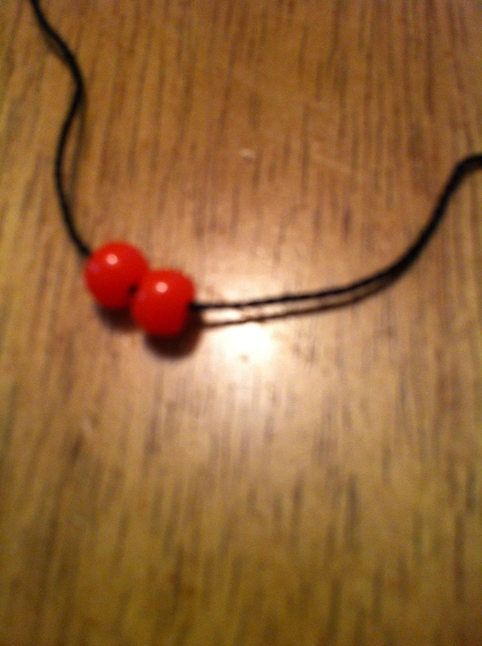 Pull the string through them.