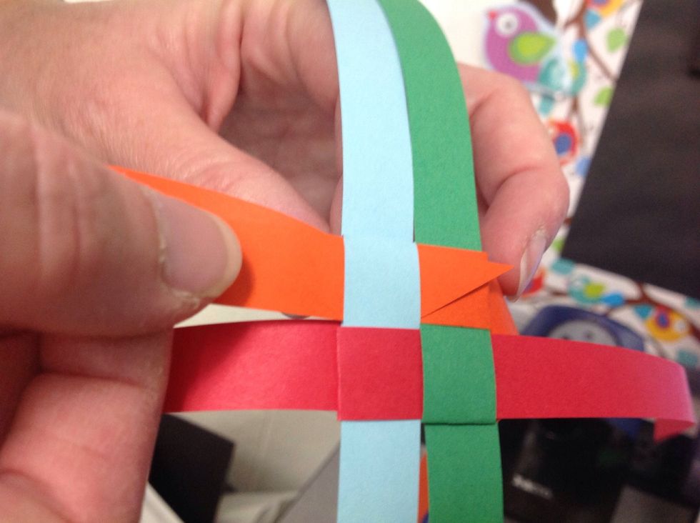 Pull the strip all the way through to form a tight triangle.