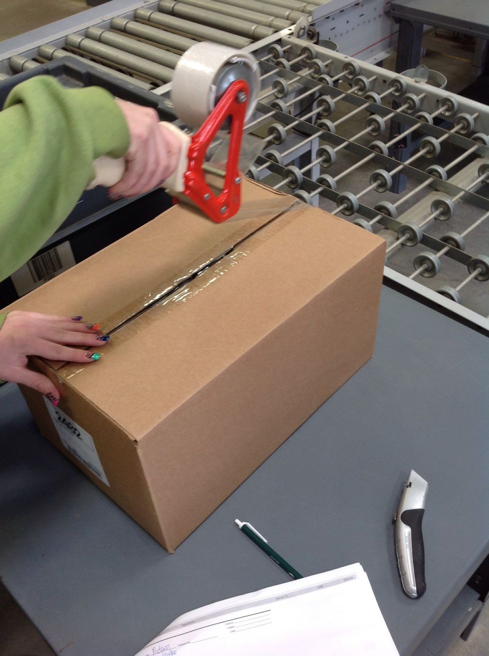 Pull the tape gun towards you as tape is dispensed from the tape gun.