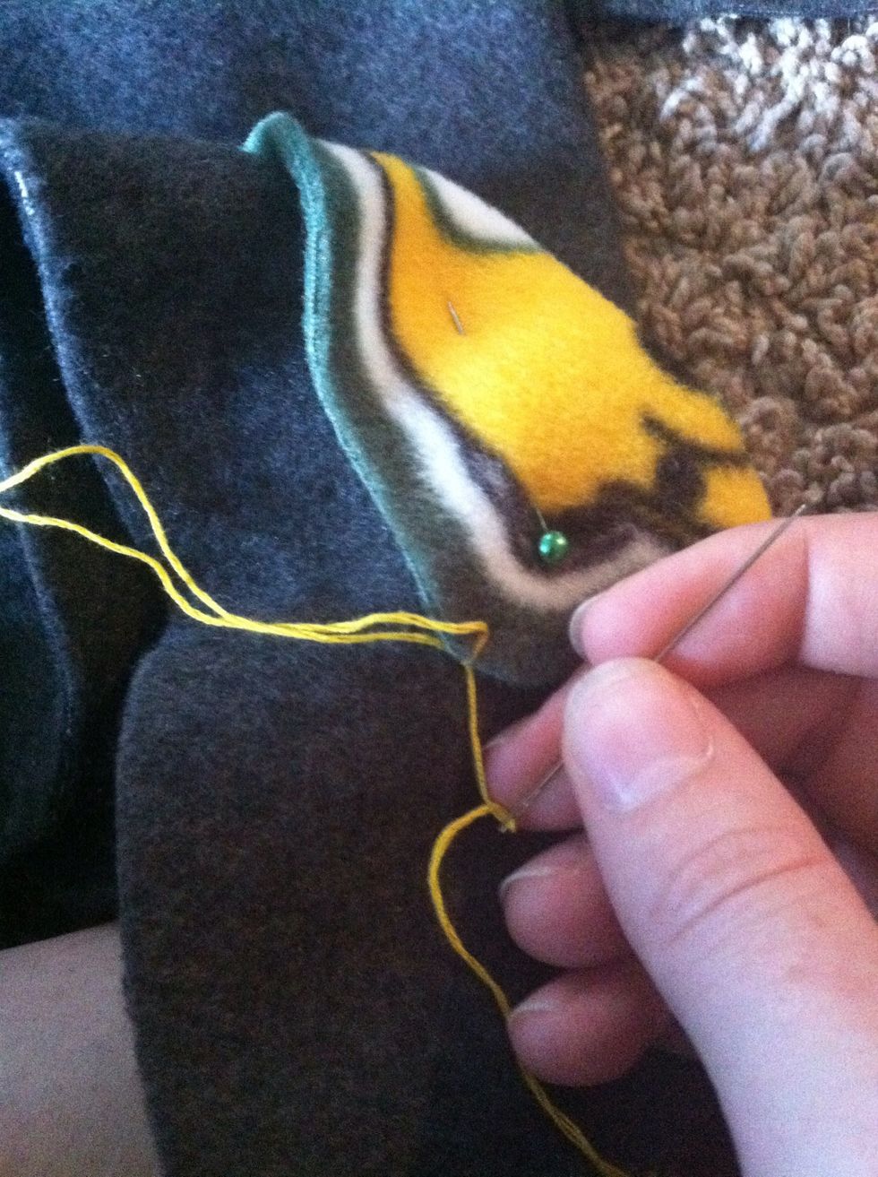 Pull the thread through the stitch.