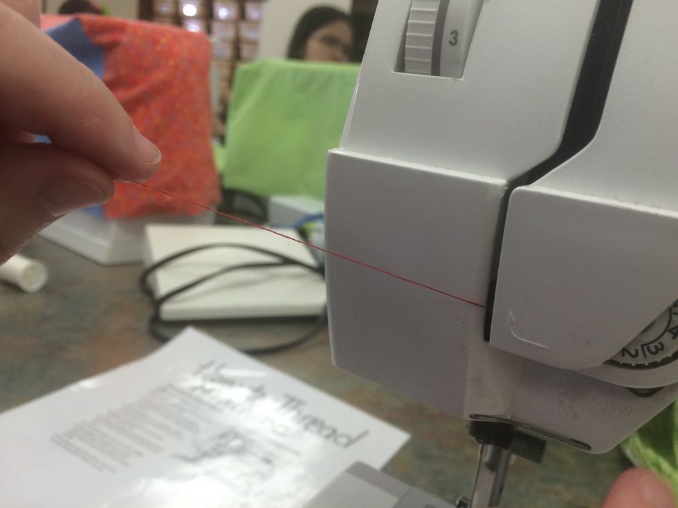 Pull the thread tight so it is up and into the tension discs (this step is VERY IMPORTANT!)