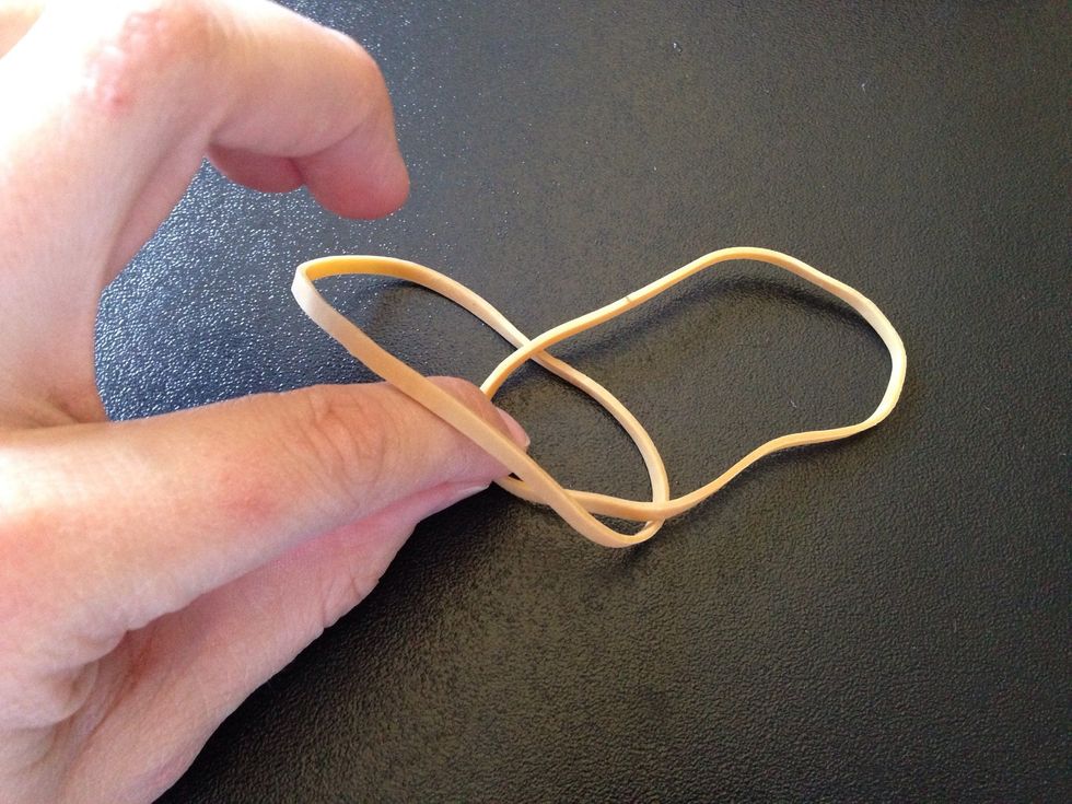 Pull the top rubber band halfway through the bottom one.