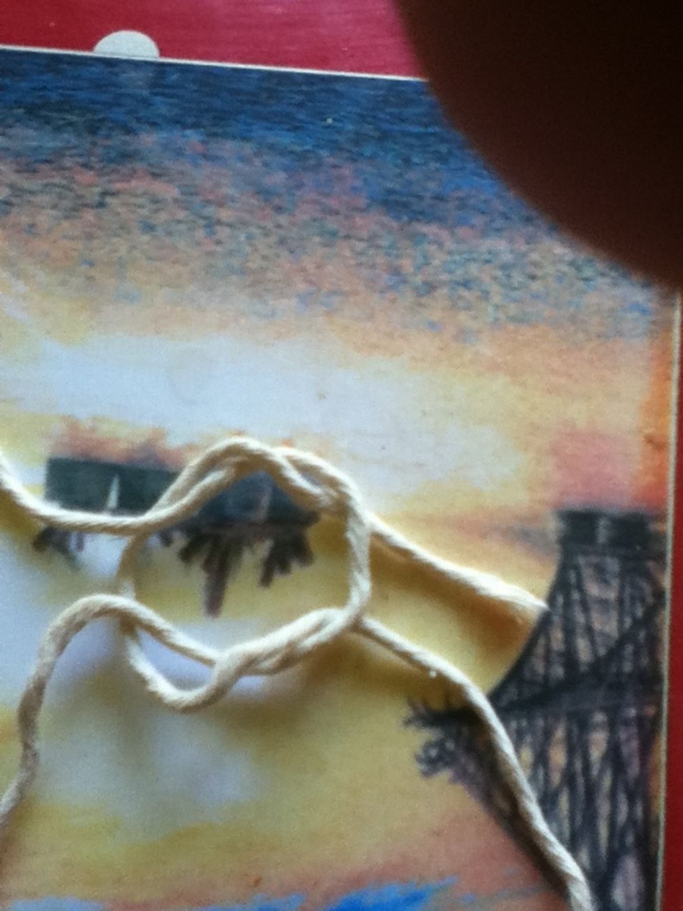 Pull the two cords on either side so that there is are two pieces of string in each hand .