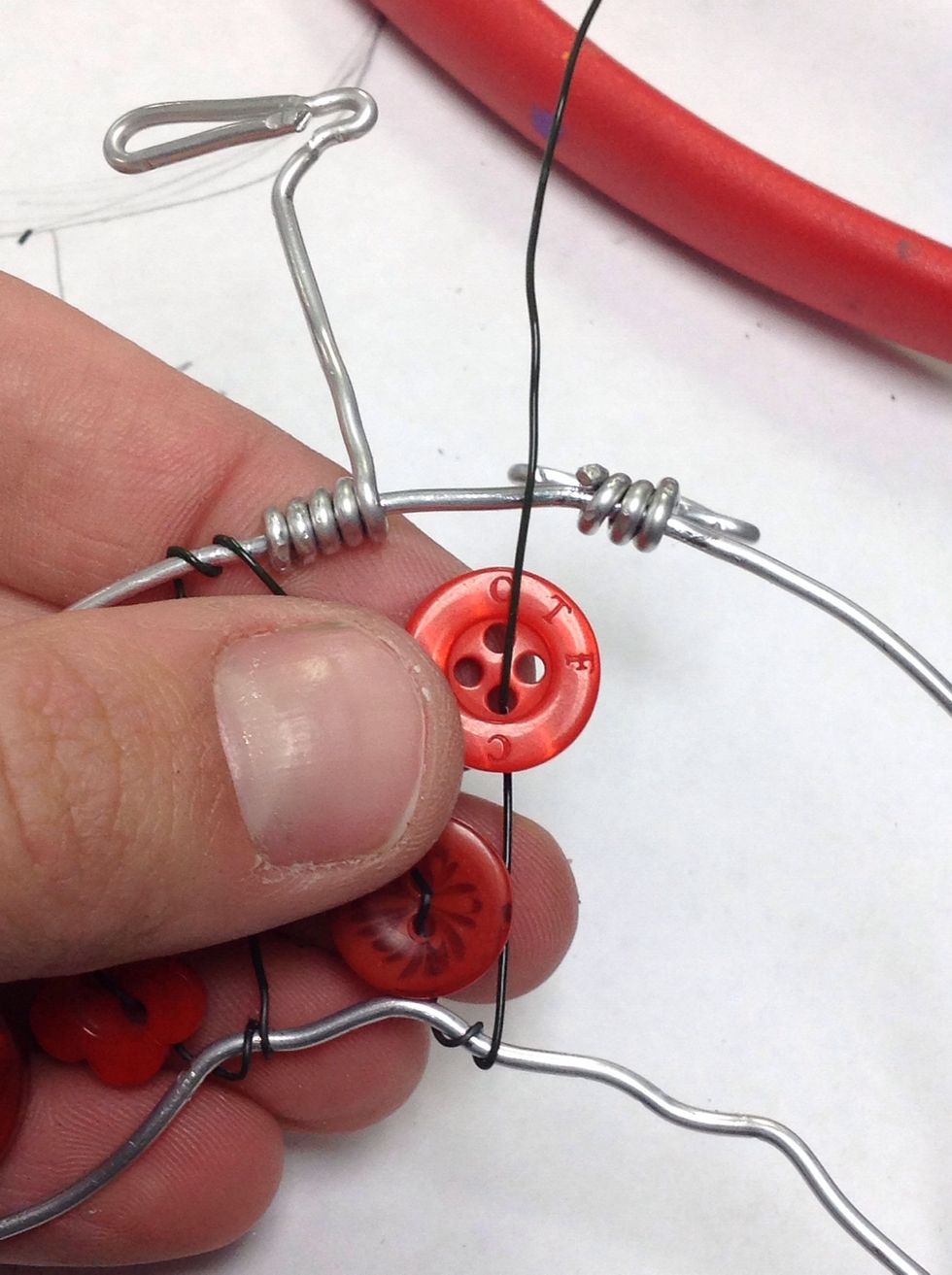 Pull the wire all the way through one hole, then pull through a second hole.