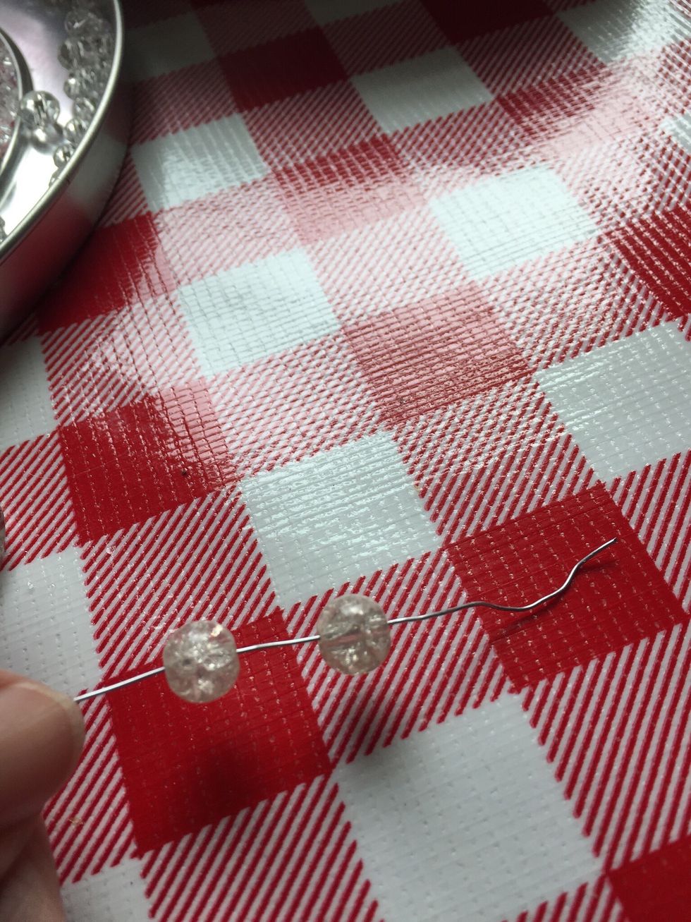 Pull the wire back down, the bead will catch the wire from coming through the spot hole. Cut the wire extra long, then begin putting your beads on wire