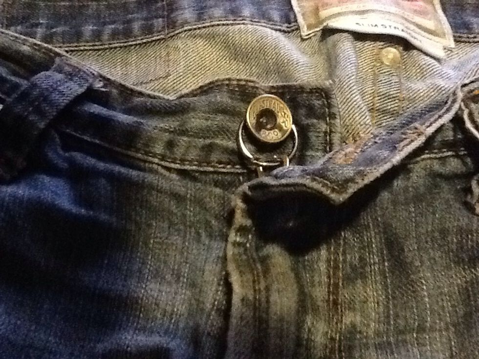 Pull the zipper up and insert the button of your jeans through the keychain ring
