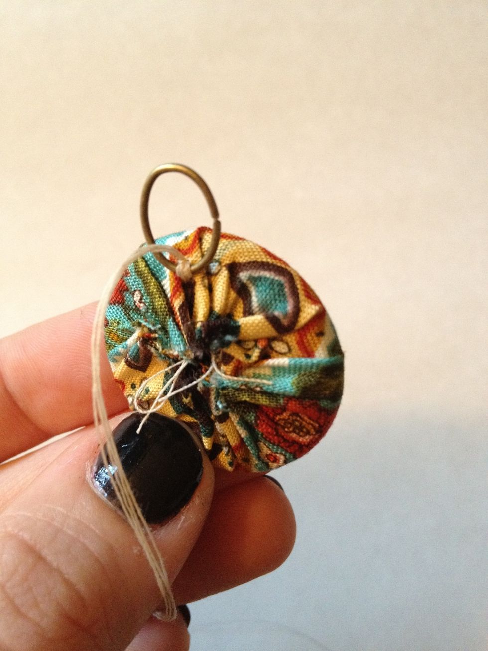 Pull thread through one large jump ring and stitch around the bottom twice (my needle is double threaded)