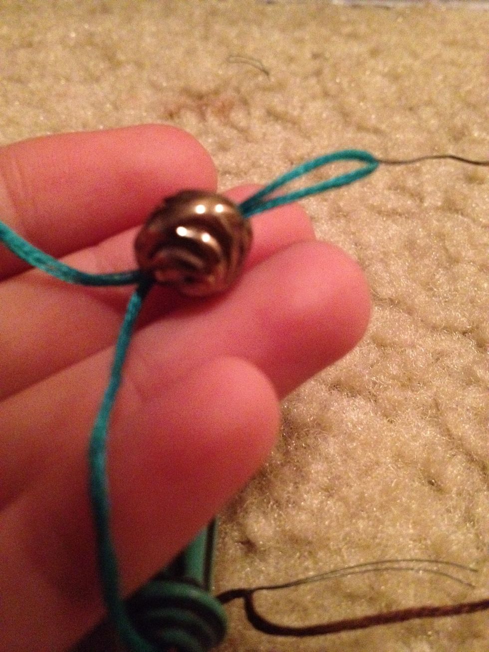 Pull through! That really helps with tiny beads! To fasten it, I put the first round bead I put on the bracelet in a little opening I made at the end of the bracelet.