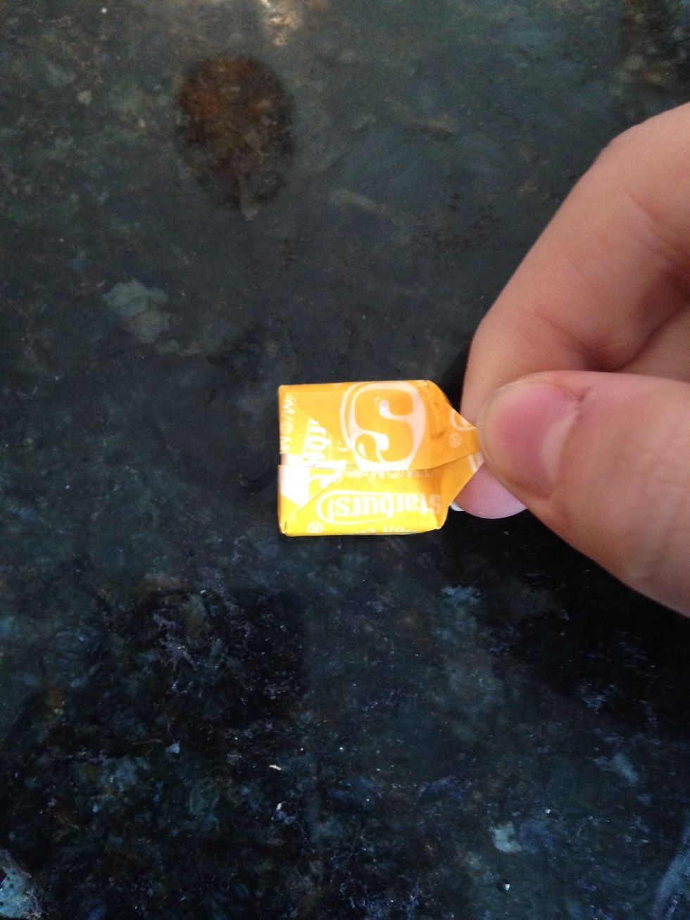 Pull up one of the triangles on the side.