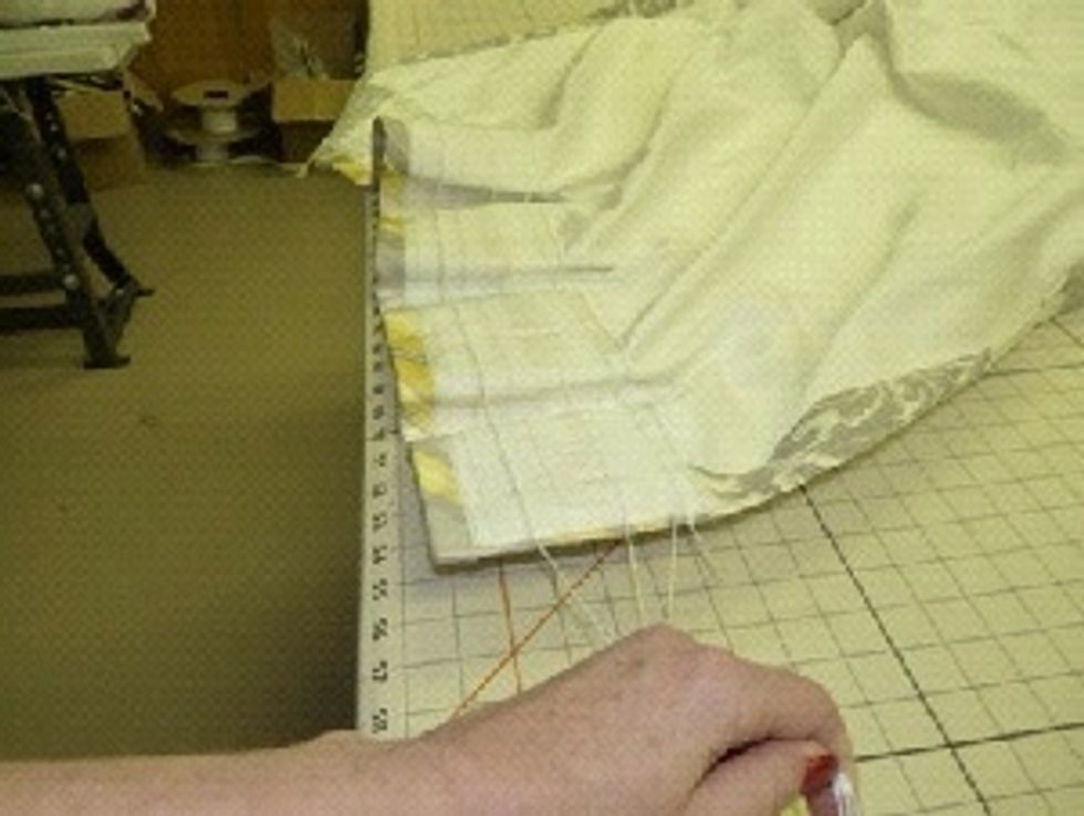 Pull up the three heavier cords to create the pleats.