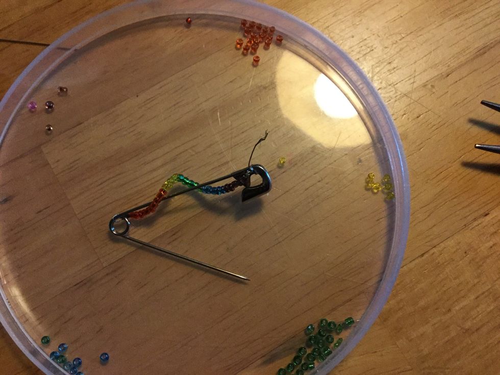 Pull wire through head of pin and through crimp bead.  Pull excess wire through crimp bead until bead is tight with pin head.  Crimp bead.  Trim wire.