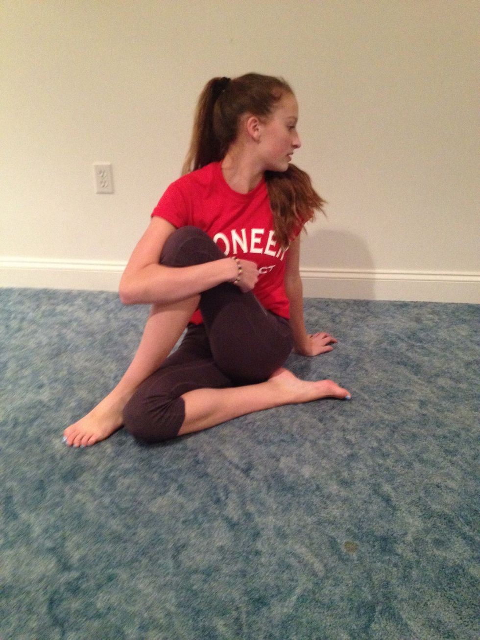 Pull your leg across your body and pull it close to you and twist to the back. Also tuck in the leg on the floor.