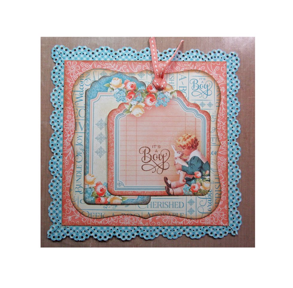 Punch a hole in the top of the tag and add a bit of ribbon. Layer another tag behind and then glue down the stamped tag.