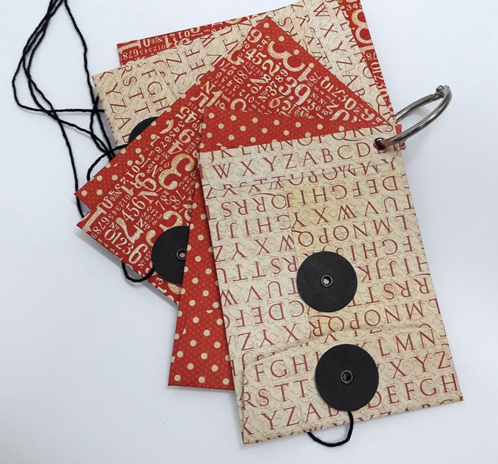 Punch a hole on the closed side of each envelope and bind with a ring.