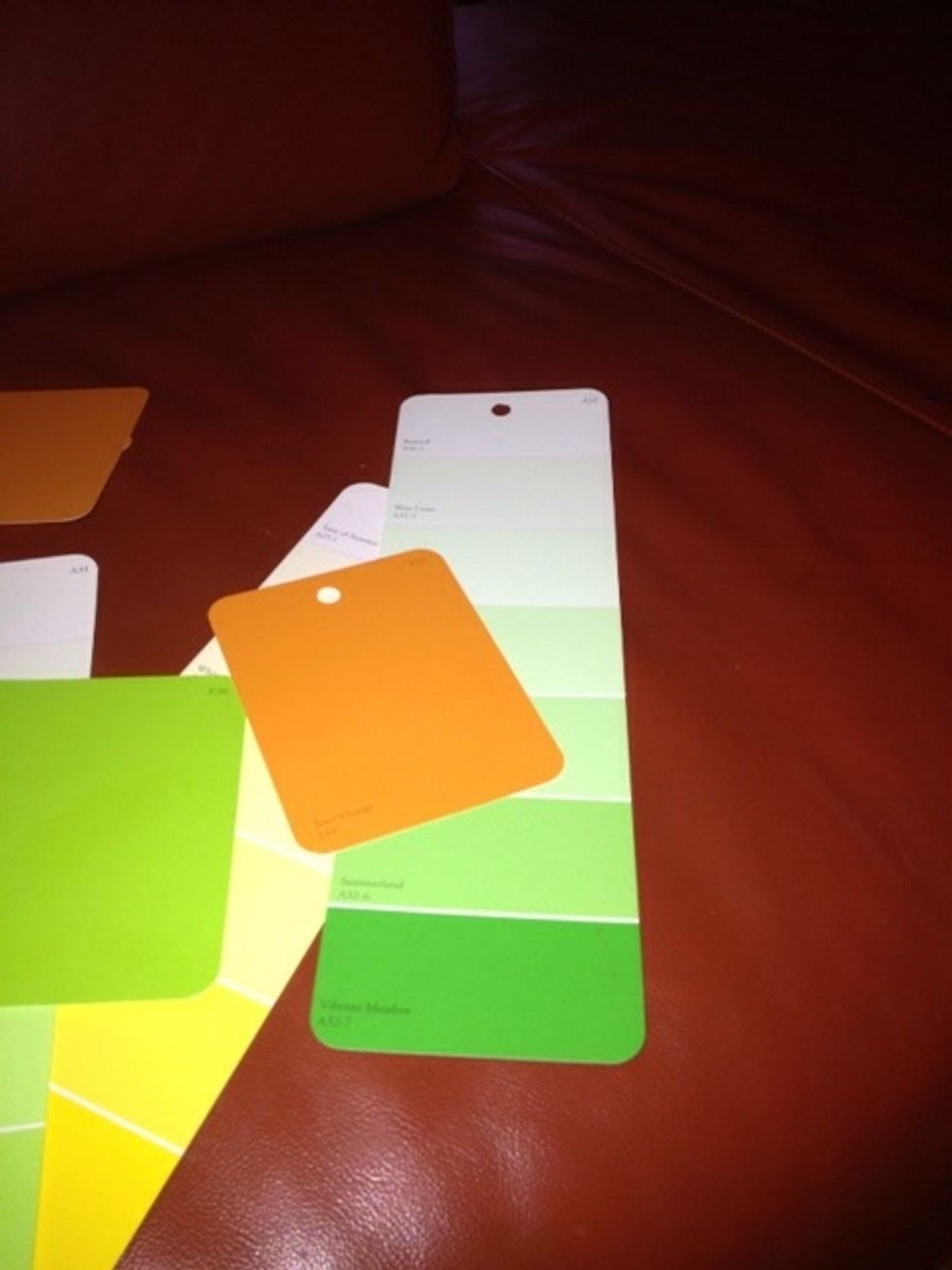 Punch a single hole in the center of the paint chip near the top. All different sizes of paint chips will work.