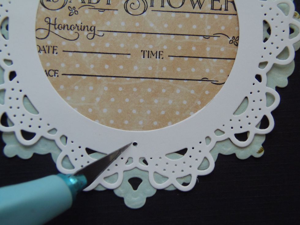 Punch a small hole through BOTH of the doilies.