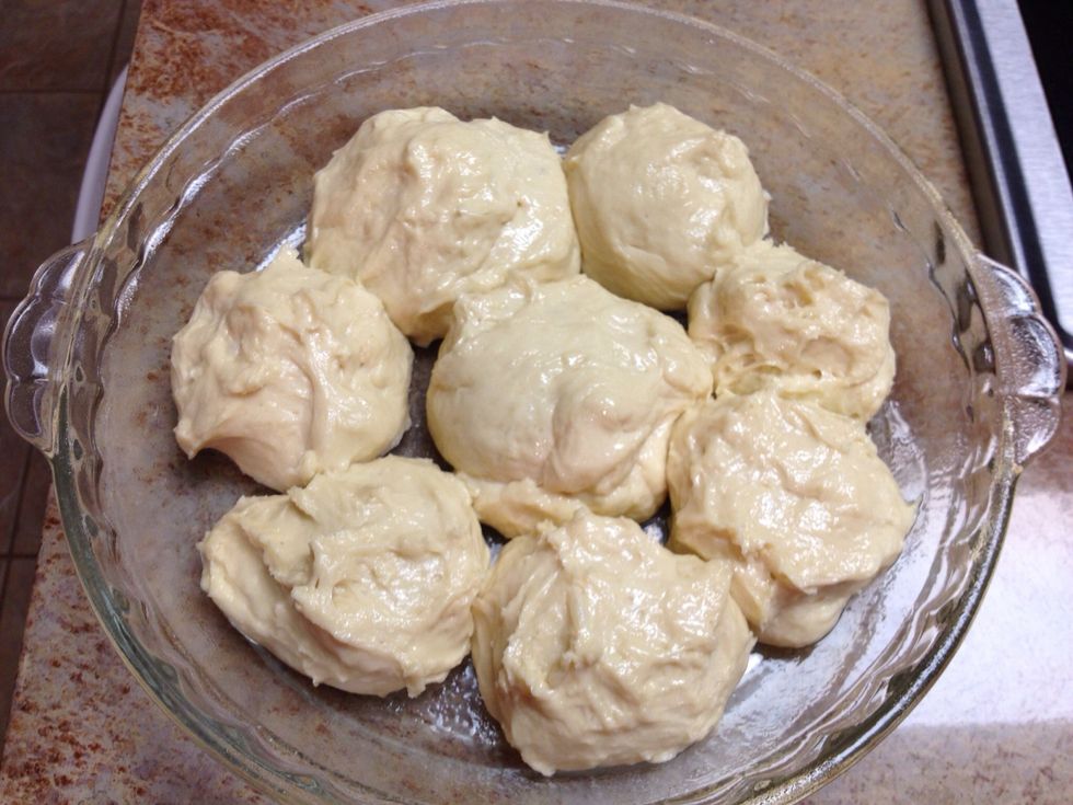 Punch down center of dough and form balls about the size of a small lime. I placed them in an oiled 9.5" pie plate, they're gooey and will touch. Cover with kitchen towel to rise for an hour