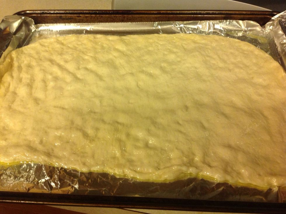 Punch down dough and roll out until it covers cookie sheet.