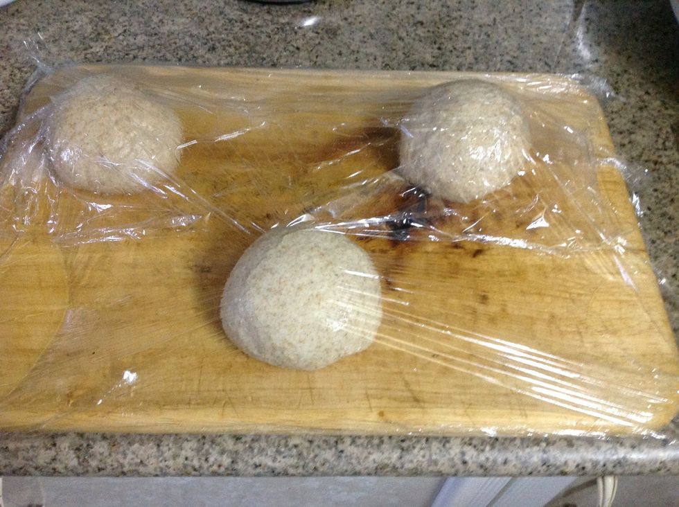 Punch down the dough and Divide into three equal portions, brush them with oil, set them 5 inches apart and cover with oiled plastic wrap and let it rest for another hour.
