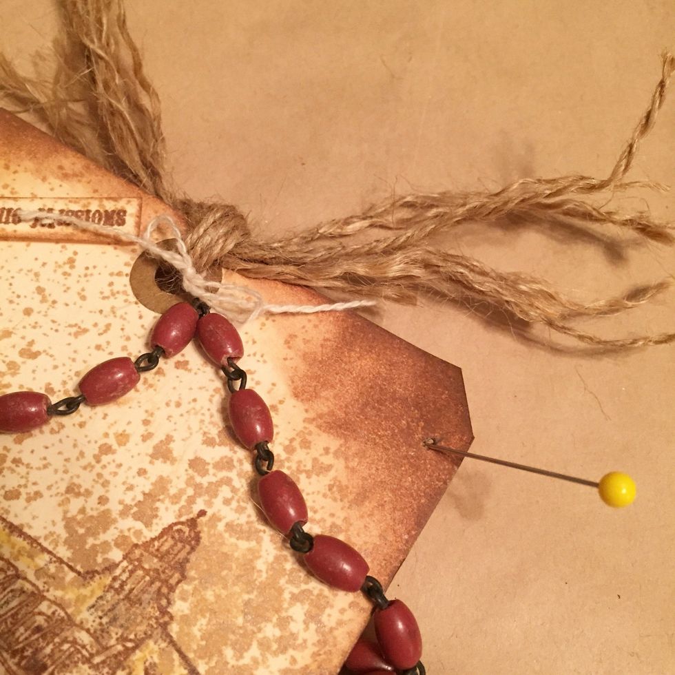 punch hole at top right of tag to use to attach bead chain