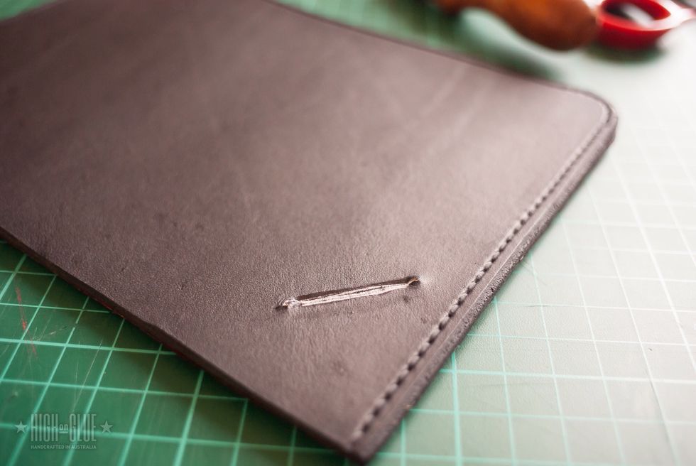 Punch holes at the top left of the back cover and create a space for the rubber band.