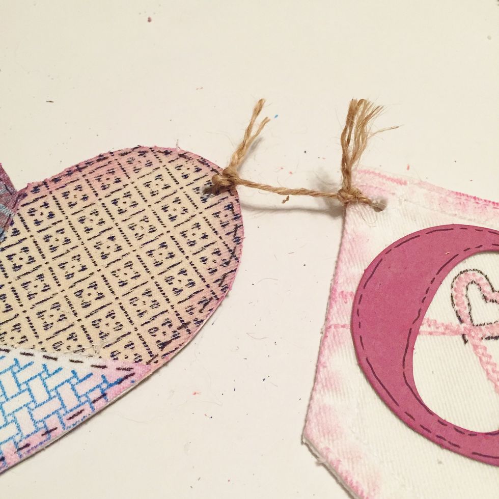 punch holes in pieces and tie together using jute. also tie longer pieces of jute at each end for hanging.