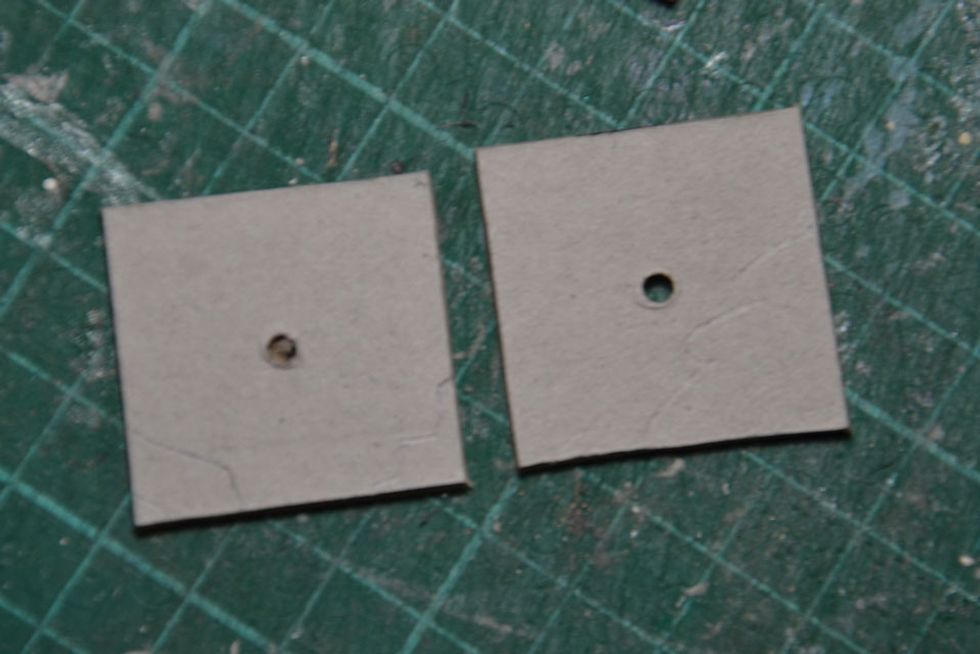 Punch holes in the centre of the top and bottom pieces of the balloon basket. These need to be just big enough to fit the skewer into.