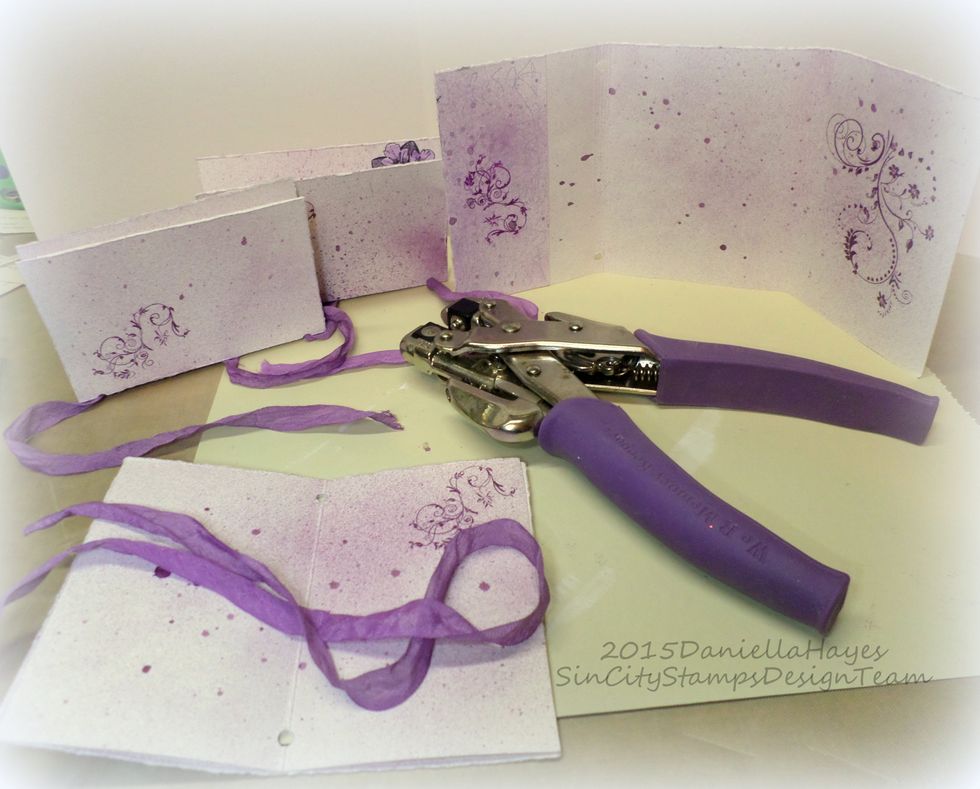 Punch holes in the signatures and the cover. Be sure to mark where you put the holes so they will all be the same. I marked mine at 1/4" from the bottom. Ink all edges before you start threading.