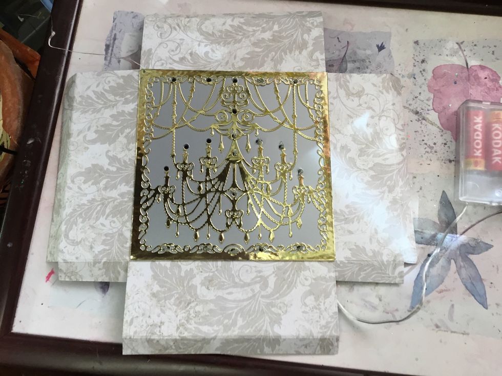 Punch holes where you want your lights to show through.  Here I have already stuck some lights in position.