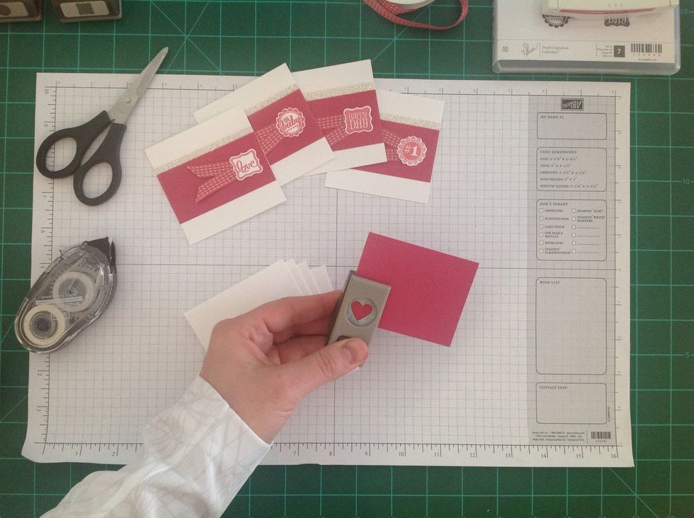 Punch out a mini heart for the back of each envelope.