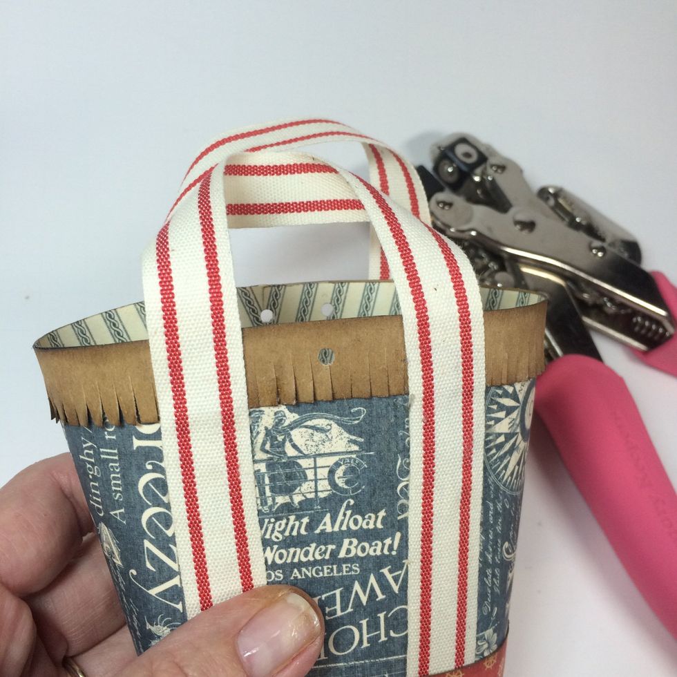 Punch two small holes in the back of the tote and one hole in the front.