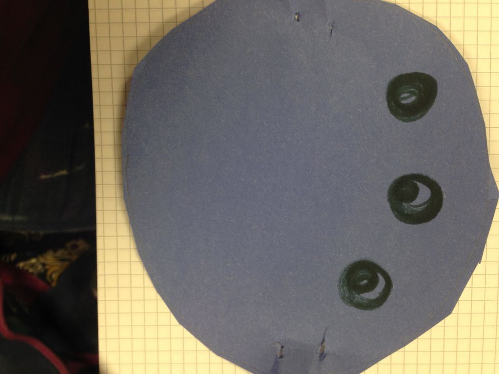 Punch two small holes on each side of spider, which will be for the legs. I used the pointy edge of a pair of scissors to make these holes.