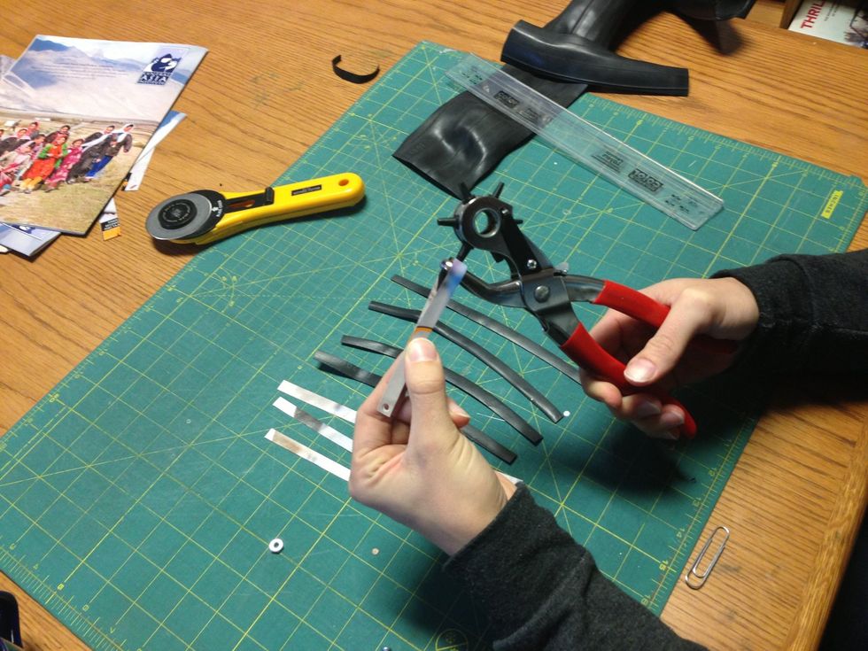 Punching a middle hole. I fold the strip in half to find the middle of the length.