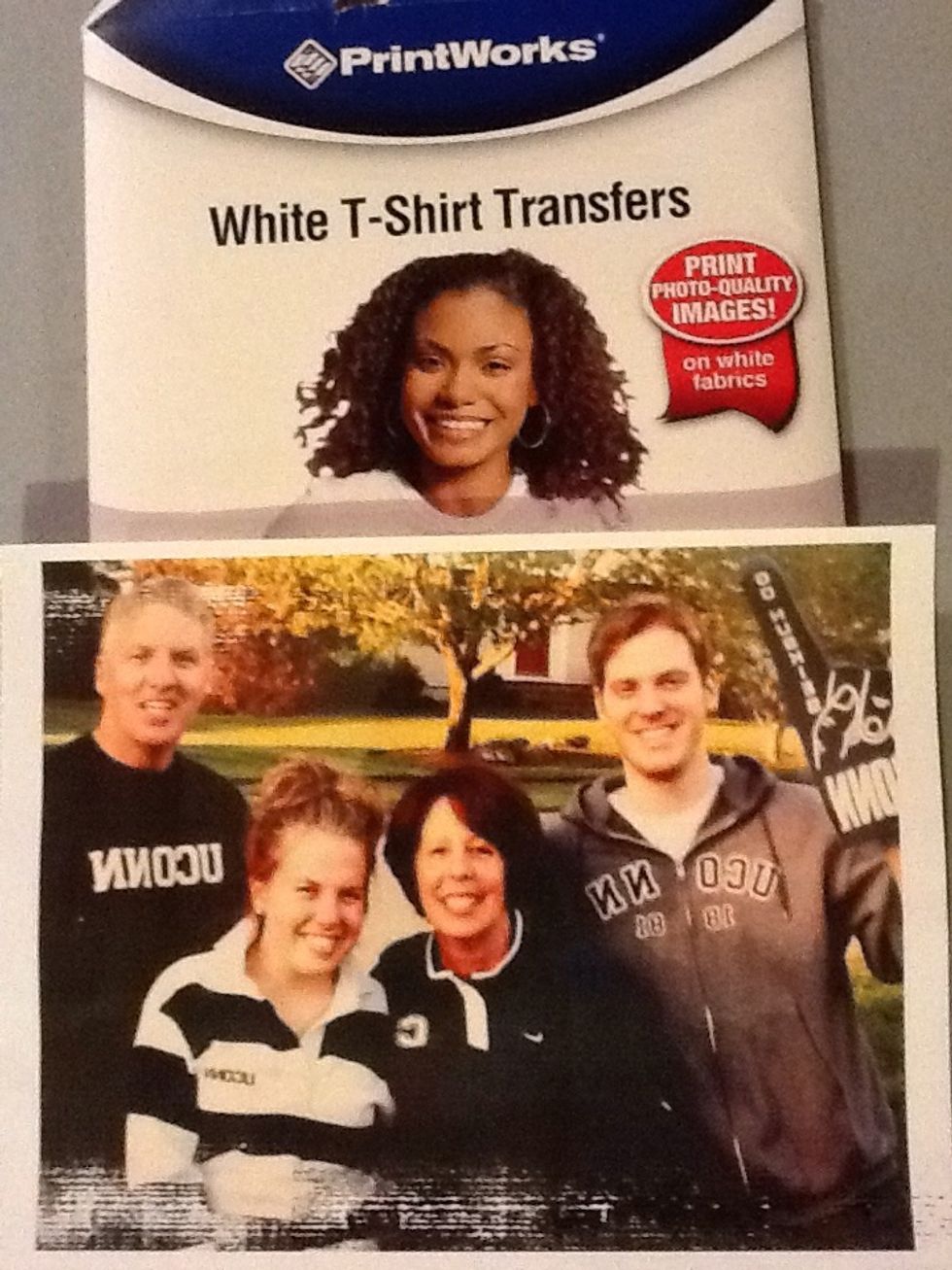 Purchase a white t-shirt photo transfer product. Follow directions for printing and ironing transfer from the product. REVERSE the photo prior to printing when there is lettering in the photo.