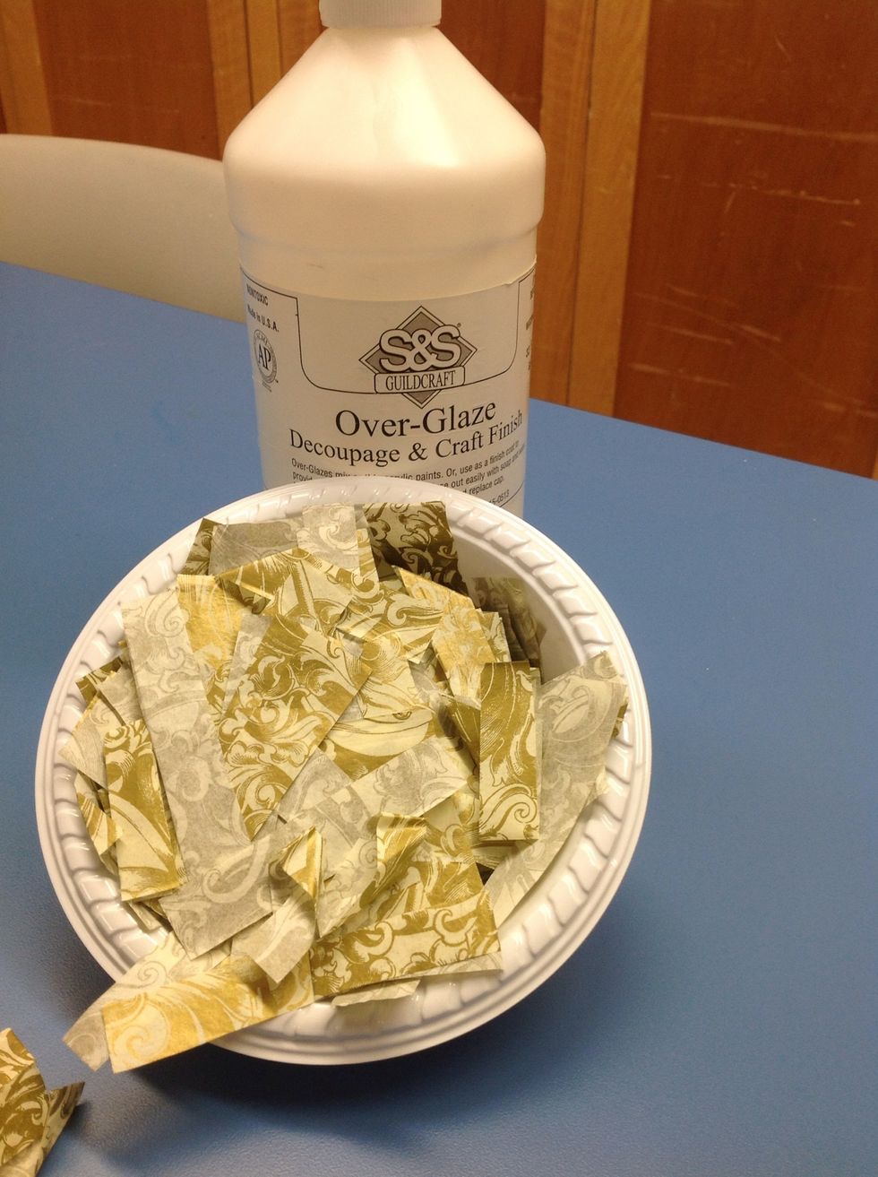 Purchase tissue paper that has a matching design and color scheme of your home. Cut tissue paper into small strips.