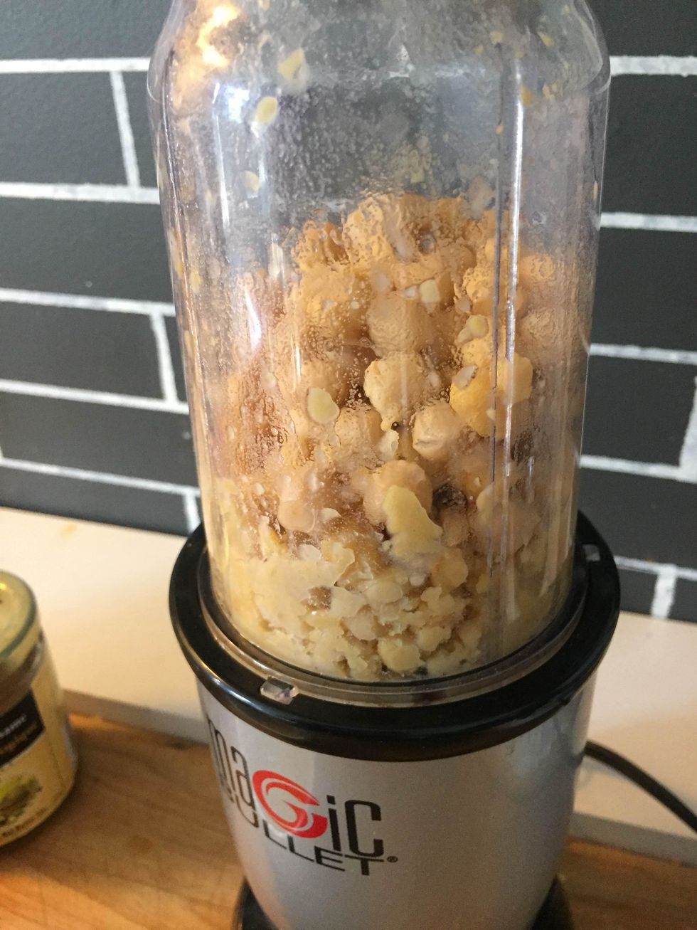 Puree the chickpeas; add the water and lemon/garlic mixture, mix.