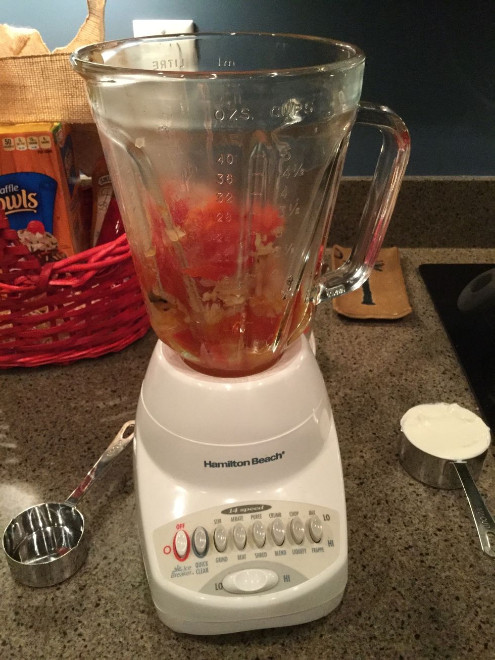 Puree the roasted vegetables (tomatoes, garlic, and onions) in a blender or food processor.
