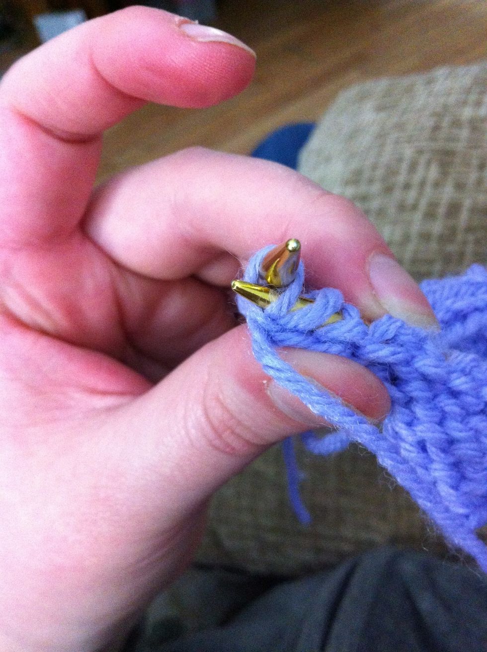 Purl again into the back if rhe stitch by twisting the stitch and inserting the needle through the back of the stitch and purling it.