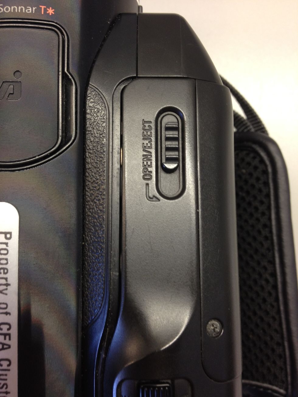 Push and slide the Open/Eject button towards you to open the lid.