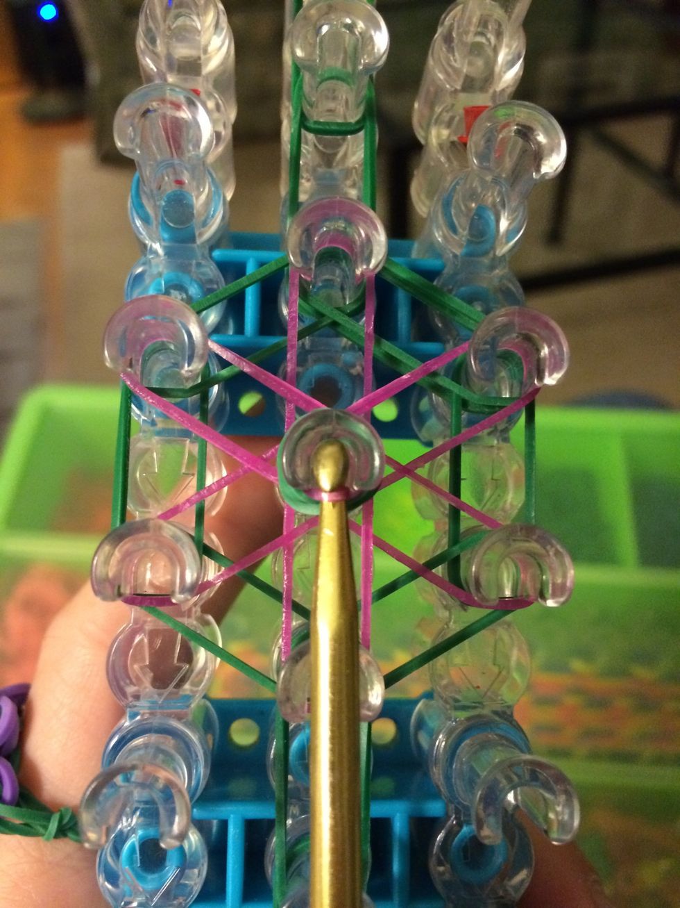 Push back your capping band and hook the 1st band on top. Loop it to the left.