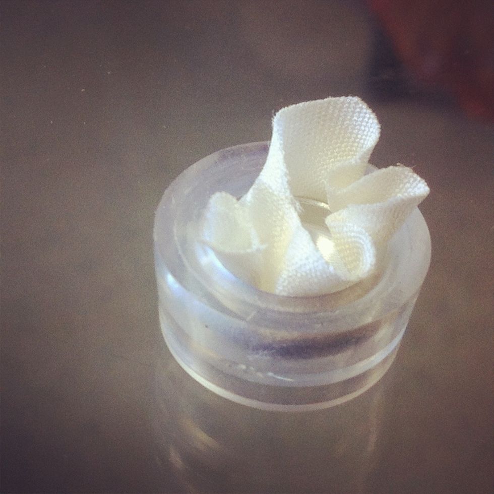 Push button part all the way into rubber cup. Trim excess fabric with scissors.