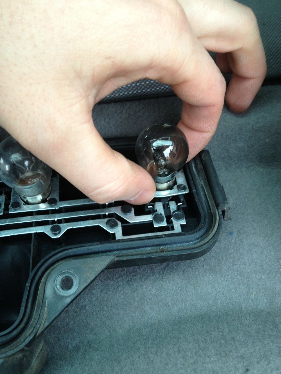 Push down and twist to take the bulb out.